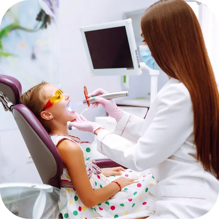 Lovely little girl smiling after doing examination in a pediatric stomatology. Milk teeth care